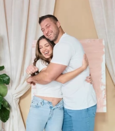 Tim and Demi-Leigh Tebow hug after finding out they are going to have a girl in March 2025. 