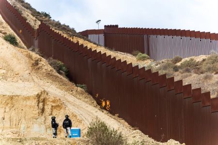 National Guard officers monitor the border wall between Mexico and the U.S. during the deployment of National Guard troops at the U.S. Border on Feb. 5, 2025, in Tijuana, Mexico. Mexico President Claudia Sheinbaum announced the deployment of 10,000 troops along the Mexico-U.S. border as part of an agreement with Trump's administration to delay an increase of 25% tariffs on exported goods. 