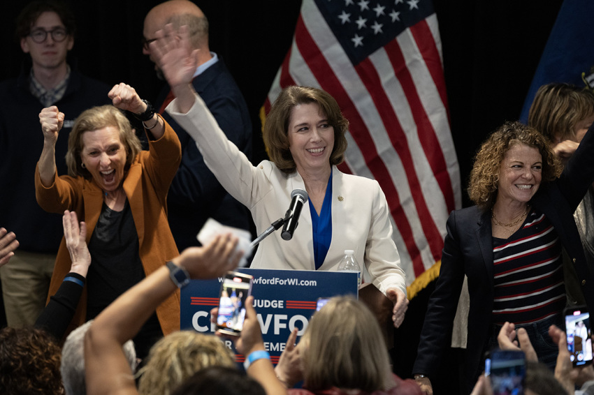 Dane County Circuit Court Judge Susan Crawford, flanked by Wisconsin Supreme Court justices, accepts victory in her race for Wisconsin Supreme Court justice on April 01, 2025, in Madison, Wisconsin. The former prosecutor ran against Judge Brad Schimel, who was endorsed by President Donald Trump and financially supported by billionaire businessman Elon Musk.