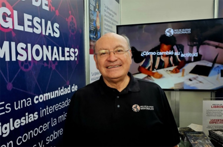 David Ruiz, former executive president of COMIBAM and veteran missions leader, stands at the exhibit booth of his ministry during the COMIBAM 2025 congress in Panama City, Panama.