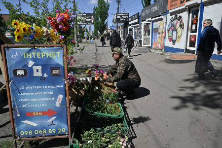 A local resident sells flowers in the town of Dobropillia, Donetsk region, on April 28, 2025, amid the Russian invasion of Ukraine.