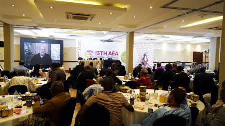 Rick Warren appears on screen via livestream as he addresses participants of the Association of Evangelicals in Africa General Assembly in Nairobi, Kenya, on May 22, 2025.