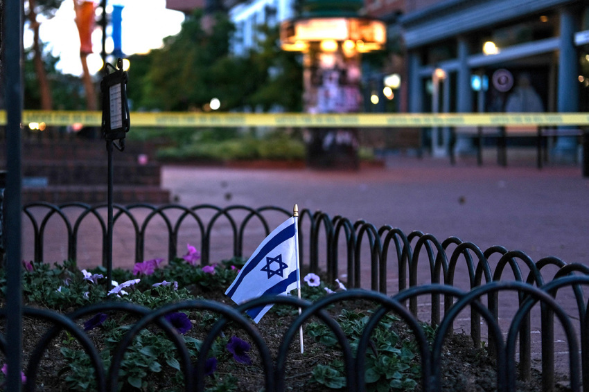 An Israeli flag stands in a bed of flowers as caution tape blocks off a deserted Pearl Street on the scene of an attack on demonstrators calling for the release of Israeli hostages held in Gaza, in Boulder, Colorado, on June 1, 2025. Several people suffered burns and other injuries in Colorado in what the FBI called a "targeted terror attack" against demonstrators seeking the release of Israeli hostages held in Gaza. Police in the city of Boulder said a man was taken into custody. They were more cautious in presuming a possible motive for the attack, which multiple sources said was committed against members of the Jewish community during a peaceful gathering.
