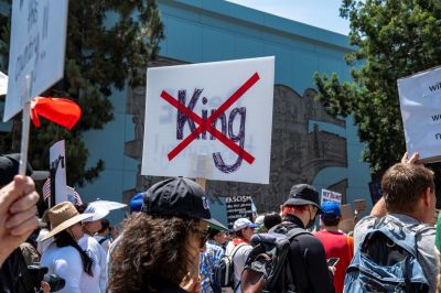 A protester holds a sign with the word 