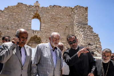 U.S. Ambassador to Israel Mike Huckabee (C) and the Palestinian mayor of the village of Taybeh, Suleiman Khourieh (L), tour the fifth century Church of St. George in the Palestinian Christian village of Taybeh, northeast of Ramallah in the West Bank, on July 19, 2025. In the villages and communities around Taybeh, Palestinian authorities have reported that settlers had killed three people and damaged or destroyed multiple water sources in the past two weeks. The July 7 arson attack on the remains of the Church of Saint George, which date back to the fifth century, was the last straw for many villagers, who blame Israeli settlers for a spate of recent attacks. 