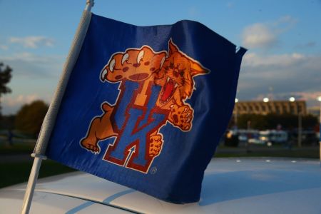 A scenic photo of a flag flying with Commonwealth Stadium on the campus of the University of Kentucky on October 25, 2013 in Lexington, Kentucky.