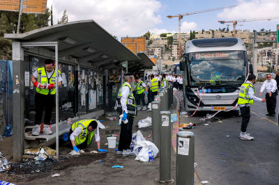 Members of Israel's ZAKA search and rescue emergency services collect samples at the scene of a shooting at the Ramot road junction in Israeli-annexed east Jerusalem on September 8, 2025. Palestinian gunmen opened fire at a bus stop in Israeli-annexed east Jerusalem on September 8, killing five people and wounding several others. Israeli emergency service Magen David Adom (MDA) said there were five victims dead in the shooting attack, updating an earlier toll of four. Police said the two gunmen were also killed.