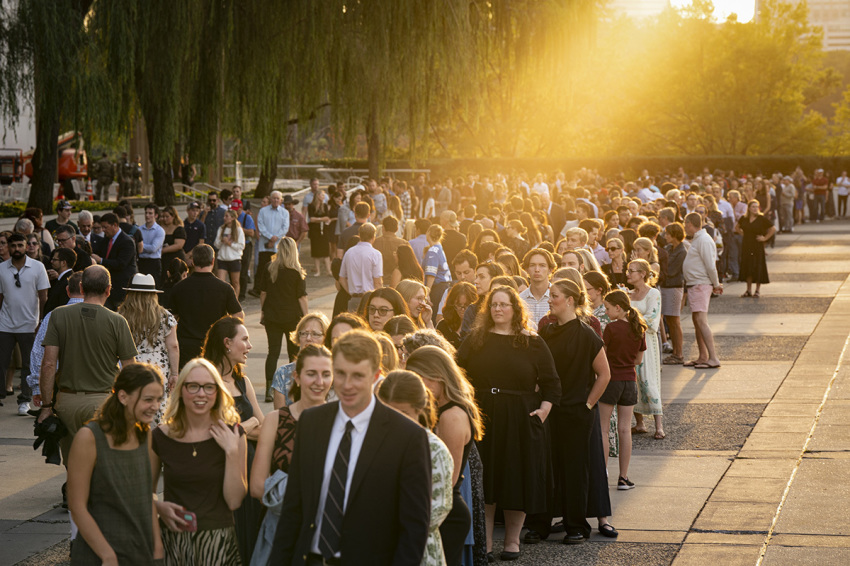 People wait in line prior to a prayer vigil for political activist Charlie Kirk outside the John F. Kennedy Center for the Performing Arts on Sept. 14, 2025, in Washington, D.C. Kirk was shot and killed by a gunman on Sept. 10 while speaking at Utah Valley University.