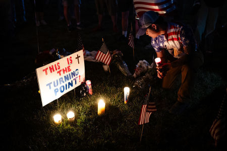 A person holds a candle in the memorial space during a Charlie Kirk vigil at Burlington Commons on September 17, 2025 in Burlington, Kentucky. Kirk, the CEO and co-founder of Turning Point USA, was shot and killed on September 10 while speaking at an event for his "American Comeback Tour" at Utah Valley University.