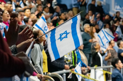 Hundreds of attendees raise Israeli flags in the auditorium of Breath of Life Church in Queens, New York, during the "New York Blesses Israel" event on Nov. 5, 2025. The congregation, which gathered more than 1,000 people, stood up to show their support and solidarity with the Jewish people in a moment described by pastors as "emotional."