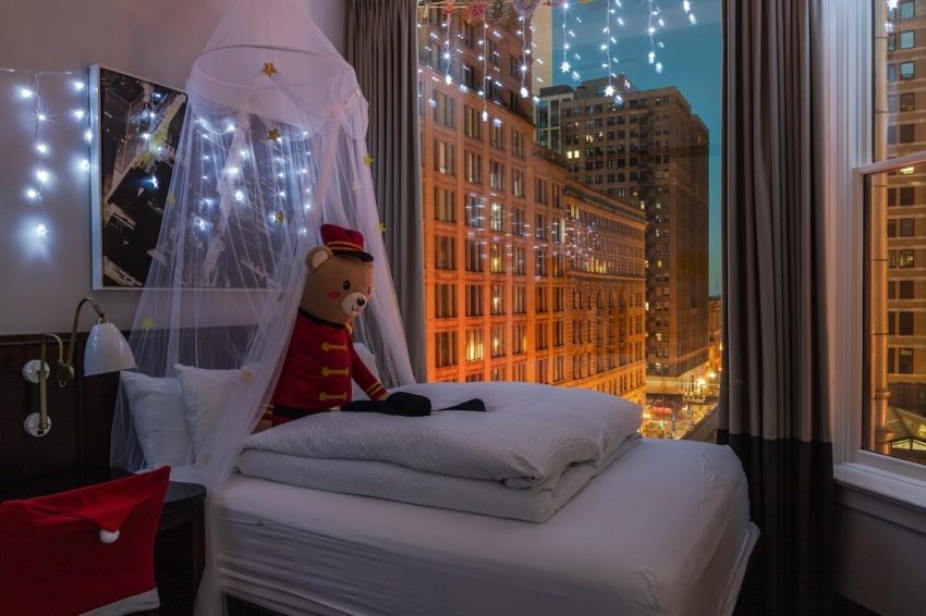 A festively decorated hotel room at Staypineapple. 