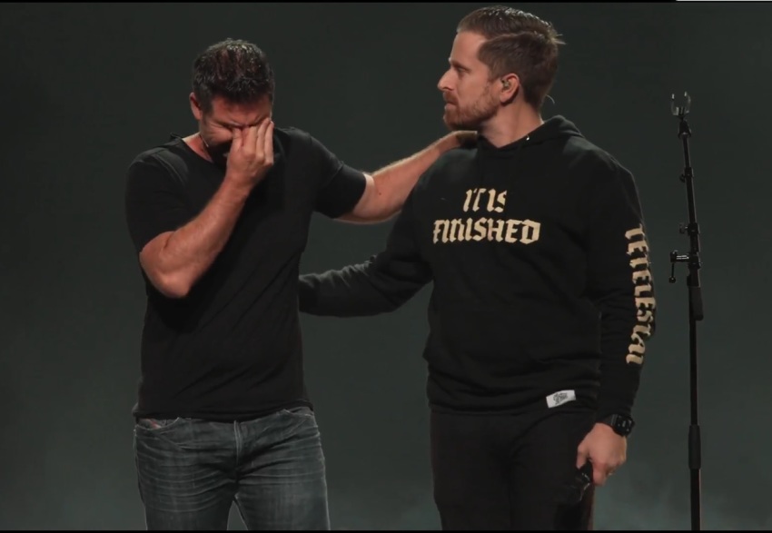 Pastor Scott Baugh (L) cries during a Nov. 30, 2025, service following the death of Pastor Josh Rene at Journey Church in Florida.