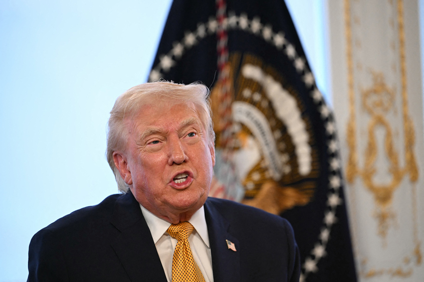 President Donald Trump participates in calls to U.S. service members on Christmas Eve from the Mar-a-Lago club in Palm Beach, Florida, Dec. 24, 2025.