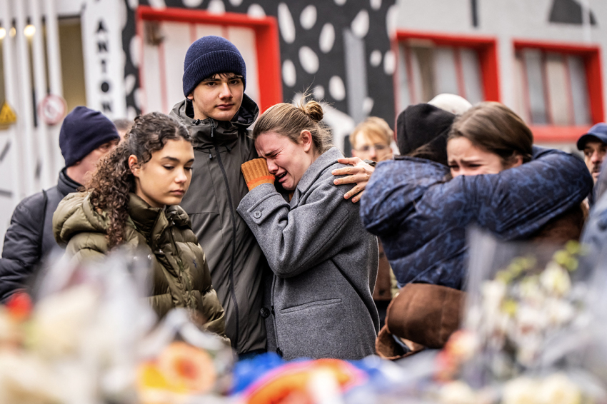 Mourners gather near the bar Le Constellation where a fire ripped through the venue during New Year's celebrations in the Alpine ski resort town of Crans-Montana killing around 40 people and injuring more than 100 others, in Crans-Montana on Jan. 2, 2026. Investigators raced on Jan. 2, 2026, to identify the victims of a fire that ripped through a bar in the Swiss Alps town of Crans-Montana, turning a New Year's celebration into one of the country's worst tragedies. Frederic Gisler, police commander in the Wallis canton in southwestern Switzerland, told reporters that authorities had counted 