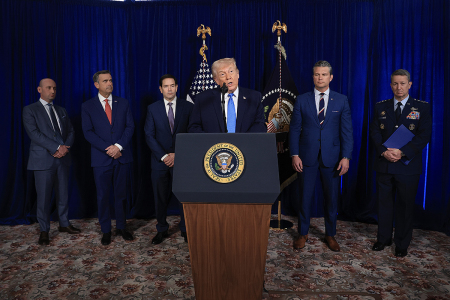 White House Deputy Chief of Staff and Homeland Security Advisor Stephen Miller, CIA Director John Ratcliffe, U.S. Secretary of State Marco Rubio, U.S. Secretary of War Pete Hegseth and Chairman of the Joint Chiefs of Staff Dan Caine listen as President Donald Trump addresses the media during a news conference at his Mar-a-Lago club on Jan. 3, 2026, in Palm Beach, Florida.