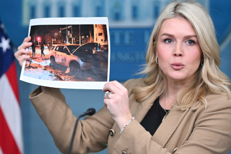 White House press secretary Karoline Leavitt holds up a picture of vandalized Immigration and Customs Enforcement (ICE) vehicles in Minnesota as she speaks during a press briefing in the Brady Briefing Room of the White House in Washington, D.C., on Jan. 15, 2026.