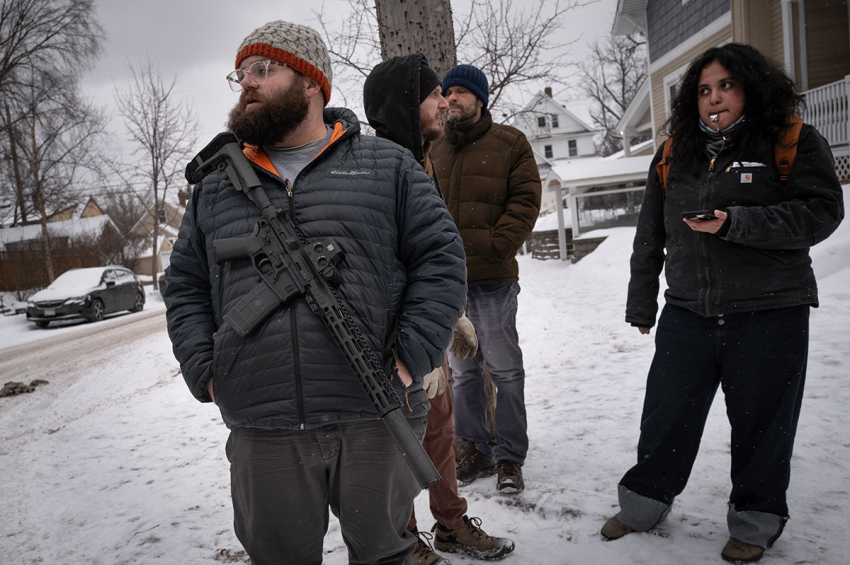 An armed man and others stand watch in a neighborhood after federal immigration agents were sighted in the area on Jan. 18, 2026, in St Paul, Minnesota. Residents in some places have organized amid a reported deployment of 3,000 federal agents in the area who have been tasked with rounding up and deporting criminal illegal immigrants, such as those who have committed rape, murder and violent sexual assault of women and children.