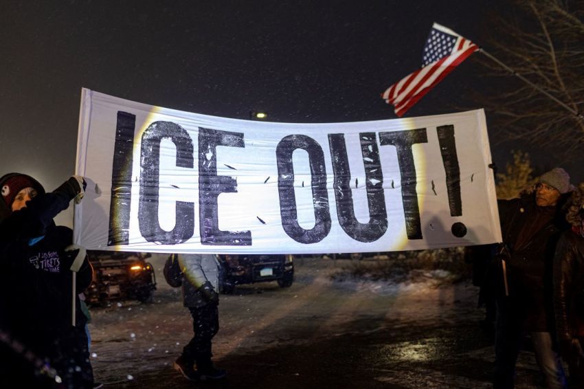 Protesters with a large anti-ICE sign stand outside the Henry Bishop Whipple Federal building on January 18, 2026, in Minneapolis, Minnesota. Protesters continued to gather to demonstrate against an ongoing immigration enforcement dubbed "Operation Metro Surge."