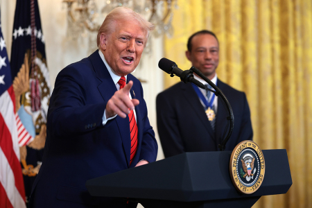 U.S. President Donald Trump, joined by golf legend Tiger Woods, speaks during a reception honoring Black History Month in the East Room of the White House on Feb. 20, 2025, in Washington, D.C.