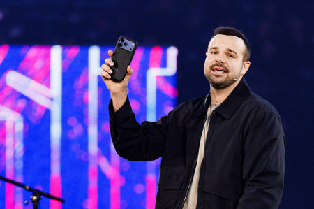 Liberty University alumnus Zach Clinton (’19), author of “Even If” and host of the "Built Different" podcast, holds up a mobile phone during a "Convocation" event in Lynchburg, Virginia, on Jan. 30, 2026.