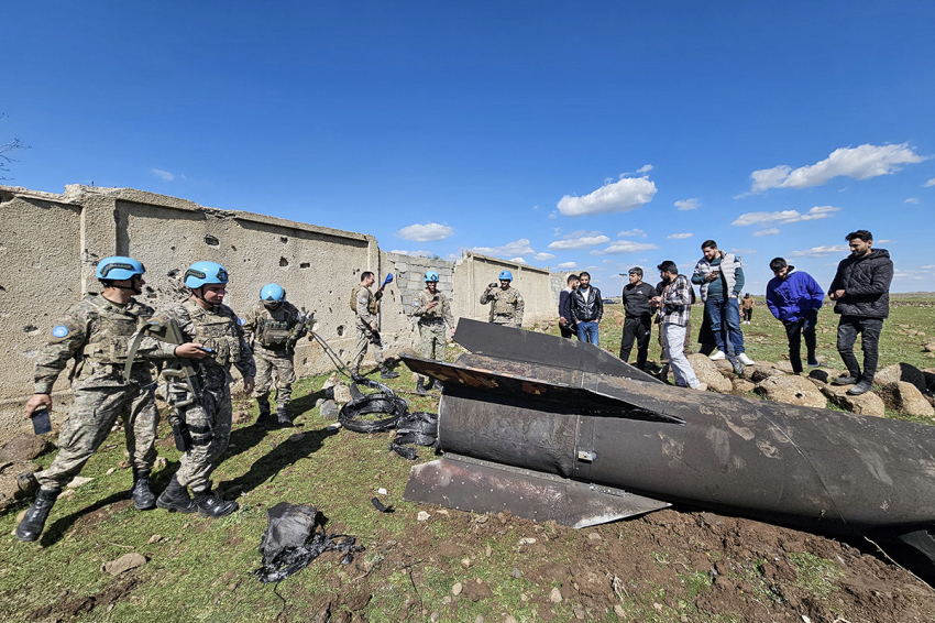 United Nations peacekeepers and civilians stand near the wreckage of an Iranian rocket that was reportedly intercepted by Israeli forces in the southern Syrian countryside of Quneitra, near the Golan Heights, close to the town of Ghadir al-Bustan. The United States and Israel launched strikes against Iran on Feb. 28, with Israel's public broadcaster reporting that supreme leader Ayatollah Ali Khamenei had been targeted, as the Islamic republic retaliated with barrages of missiles at Gulf states and Israel. 