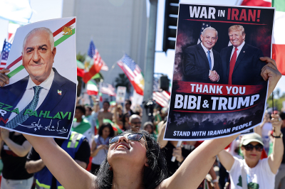 A woman holds pictures of exiled Iranian crown prince Reza Pahlavi, Israeli Prime Minister Benjamin Netanyahu, and U.S. President Donald Trump as members of the Iranian community and supporters celebrate on Feb. 28, 2026, in Los Angeles, California. President Donald Trump announced that the United States and Israel had launched an attack on Iran Saturday morning.