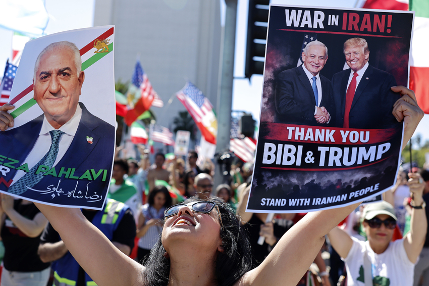 A woman holds pictures of exiled Iranian crown prince Reza Pahlavi, Israeli Prime Minister Benjamin Netanyahu, and U.S. President Donald Trump as members of the Iranian community and supporters celebrate on Feb. 28, 2026, in Los Angeles, California. President Donald Trump announced that the United States and Israel had launched an attack on Iran on Saturday morning. 