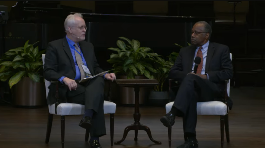 John G. West (left) and Dr. Ben Carson during a panel discussion as part of the Discovery Institute's Dallas Conference on Science & Faith at Park Cities Baptist Church in Dallas, Texas, on Feb. 28, 2026.