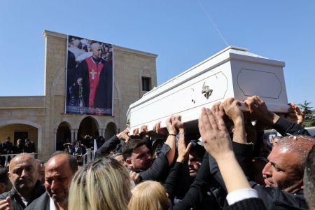Residents of the Christian Lebanese border village of Qlayaa carry the coffin of the village's priest, Father Pierre al-Rahi, during his funeral on March 11, 2026. Fighting flared last week between Israel and Lebanese militant group Hezbollah as part of a wider regional war, prompting the Israeli military to warn people across swathes of southern Lebanon to flee. Farther east in the village of Qlayaa, a parish priest died on March 9 of wounds sustained from Israeli tank fire, sparking anger and fear. 