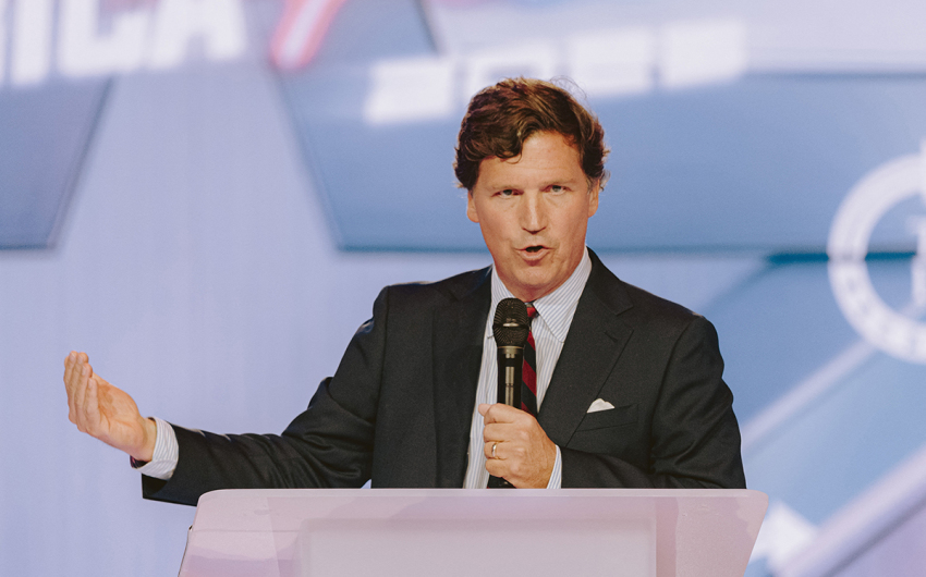Conservative political commentator Tucker Carlson speaks at Turning Point USA's annual AmericaFest conference in remembrance of the late political activist Charlie Kirk, in Phoenix, Arizona, on Dec. 18, 2025.