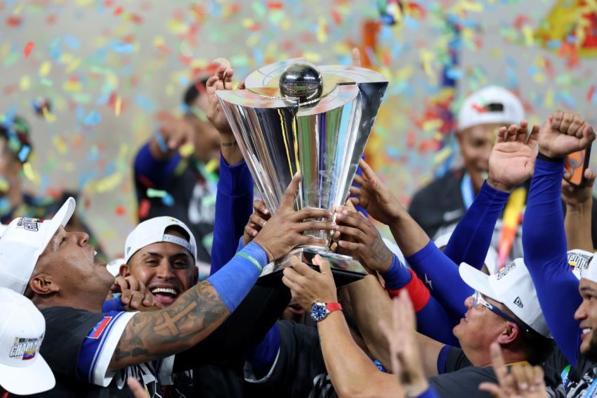 Salvador Perez #13 and manager Omar López #22 of Team Venezuela lift the championship trophy after defeating Team United States 3-2 at loanDepot park on March 17, 2026, in Miami, Florida. 