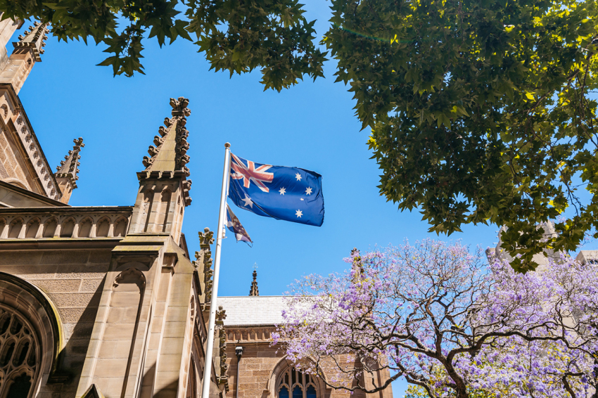 Australian flag waving at Saint Andrew's Cathedral in Sydney, Australia.