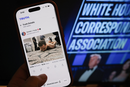 This illustration photo taken in Los Angeles shows a phone with a Truth Social post by U.S. President Donald Trump displaying an image of the alleged suspect in a shooting incident at the White House Correspondents' Dinner on the ground after being apprehended on April 25, 2026. U.S. Secret Service agents bundled Donald Trump from the stage as shots rang out Saturday evening at a media gala, in what the president later described as an attack by a