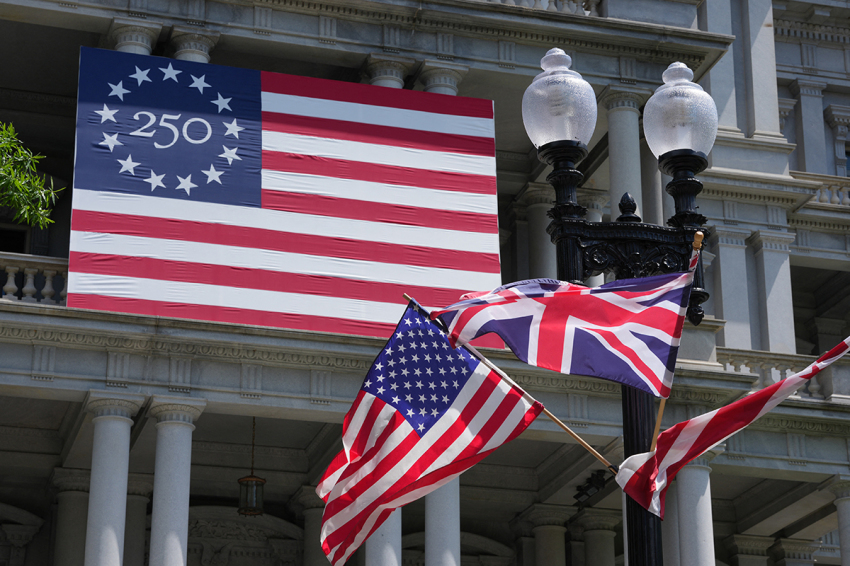 U.S. and U.K. flags fly near a flag celebrating the United States' 250th anniversary of independence ahead of the state visit of Britain's King Charles III and Britain's Queen Camilla in Washington, D.C., on April 27, 2026. King Charles III arrives in Washington Monday for a high-stakes state visit aimed at salvaging Britain's frayed ties with Donald Trump, amid extra-tight security following an attack on a gala dinner attended by the U.S. president. Tensions over the Iran war have rocked the so-called
