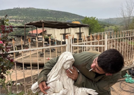 An IDF soldier photographed placing a cigarette into the mouth of a statue of the Virgin Mary, in a Christian village in southern Lebanon.