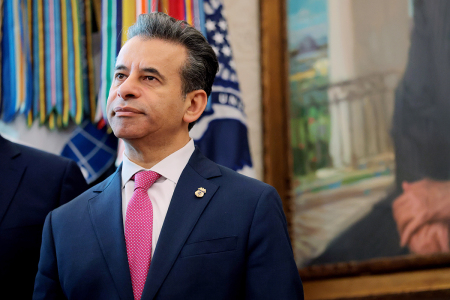 Food and Drug Administration Commissioner Marty Makary listens as U.S. President Donald Trump speaks before signing an executive order in the Oval Office of the White House on Dec. 18, 2025, in Washington, D.C. Trump signed the order reclassifying marijuana as a schedule III drug.