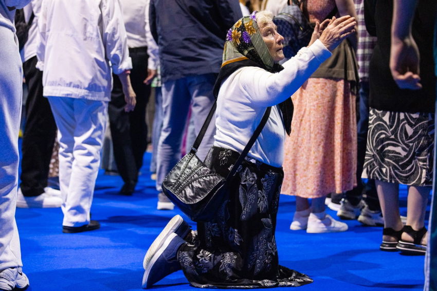 A woman prays during the Belarus Festival of Hope outreach event at the Chizhovka Arena in Minsk, Belarus, held from May 16 to 17, 2026. 