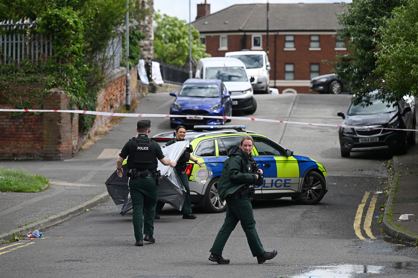 Police attend the scene following a stabbing attack in North Belfast on June 09, 2026, in Belfast, Northern Ireland. A Sudanese knifeman has been arrested after a man was taken to hospital with serious injuries following a brutal stabbing in north Belfast leaving the local community fearful. 