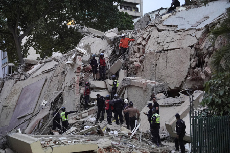 Rescuers search for victims in a collapsed building following an earthquake in Caracas on June 24, 2026. Two earthquakes of magnitude 7.2 and 7.5 struck the same area of Venezuela on the evening of June 24, causing buildings to collapse, according to the United States Geological Survey (USGS) and AFP journalists. The quakes drove residents of the capital, Caracas, into the streets.