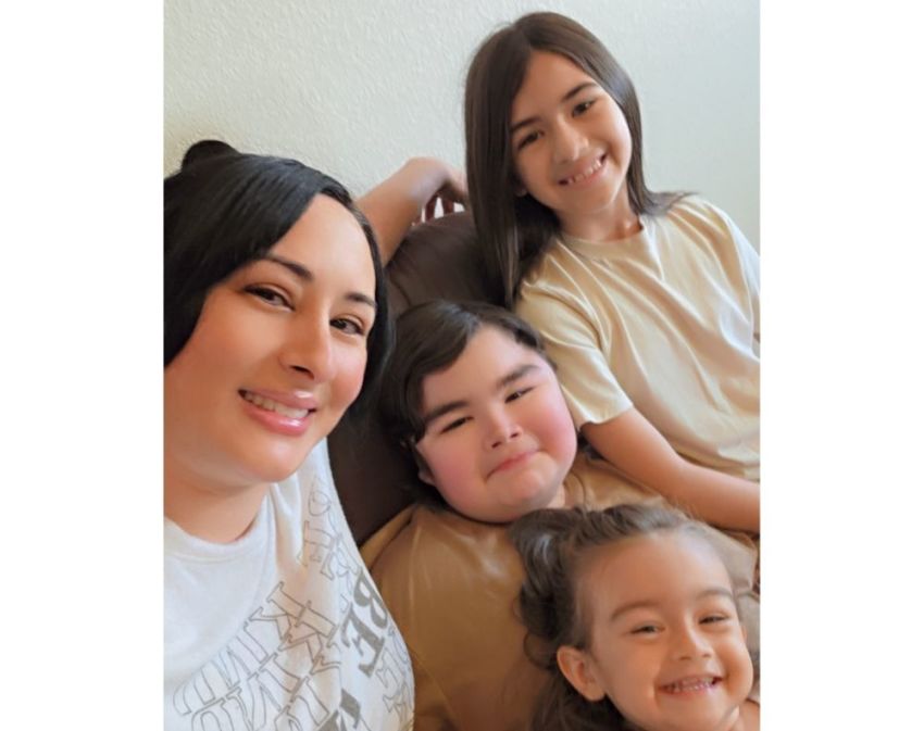 Angelina Olivera (L) and her children, including her son, Ryu (M), who has Duchenne muscular dystrophy.