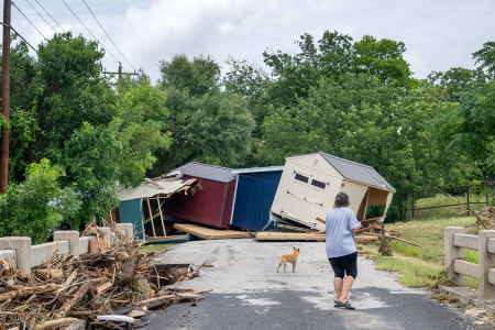 A person assess flood damage near the banks of the Guadalupe River on July 17, 2026, in Kerrville, Texas. Flash floods swept across parts of Central Texas, bringing torrential rainfall, prompting evacuations, and triggering hundreds of water rescues. At least two people have been killed, and more than 200 others have been rescued. (Photo by Brandon Bell/Getty Images)