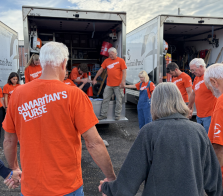 Samaritan's Purse volunteers gather in prayer as they provide assistance and spiritual support to homeowners impacted by major flooding in Ohio in August 2026.