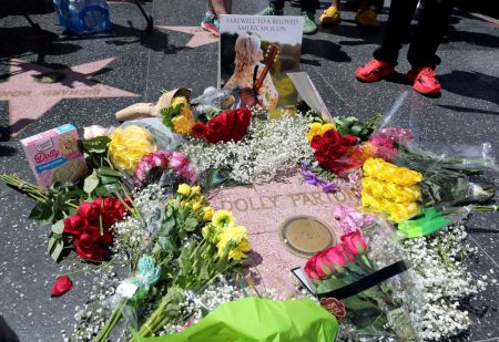 Flowers and remembrances are laid at Dolly Parton's Star on the Hollywood Walk of Fame on August 25, 2026, in Hollywood, California. Parton passed away at the age of 80 on August 25, 2026. 
