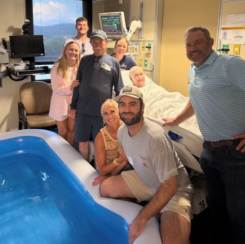 The late Jeannie Guffey's family surrounds her bed inside the Huntsville Hospital’s Medical Intensive Care Unit, where she was baptized on July 8, 2026.