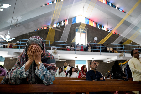 Christian devotees pray during an Easter Sunday Mass commemorating Jesus' resurrection as part of the Holy Week celebrations at the Fatima Church in Islamabad, Pakistan, on April 20, 2025.
