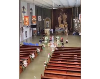 A bride and groom in the Philippines did not allow floodwater to stop them from exchanging vows at St. John the Baptist Parish in Hagonoy.