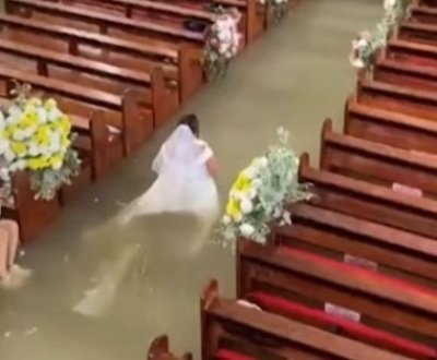 Liean Liza Chico walks down the aisle during her wedding ceremony at St. John the Baptist Parish in Hagonoy, Philippines, despite the floodwater that filled the church on Sept. 1, 2026.