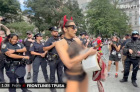 Scantily-clad trans activist wielding crucifix rips out pages of the Bible at 9/11 protest