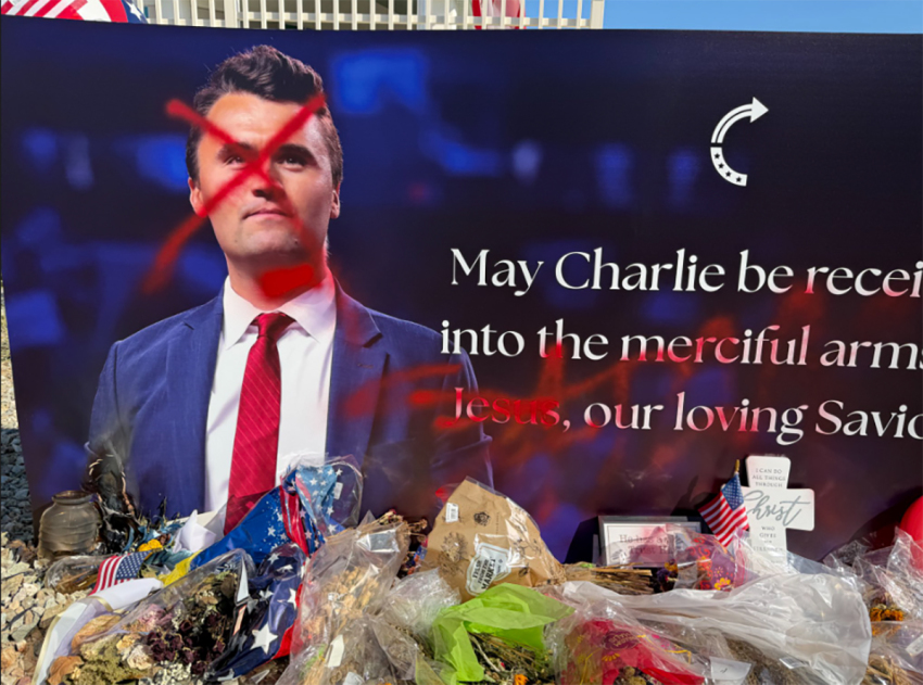A sign featuring Charlie Kirk and statue in his honor outside the headquarters of Turning Point USA in Phoenix, Arizona, were vandalized with red paint on Sept. 13, 2026. The name of Jesus was also blotted out with red spray paint.