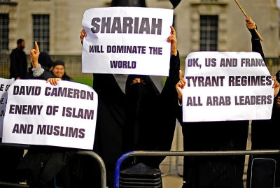 Muslim women demonstrate in favour of Sharia law during a protest outside 10 Downing Street in London, on March 21, 2011.  AFP PHOTO/Carl de Souza 